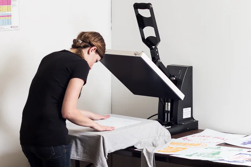 Heat press applying a design to a t-shirt