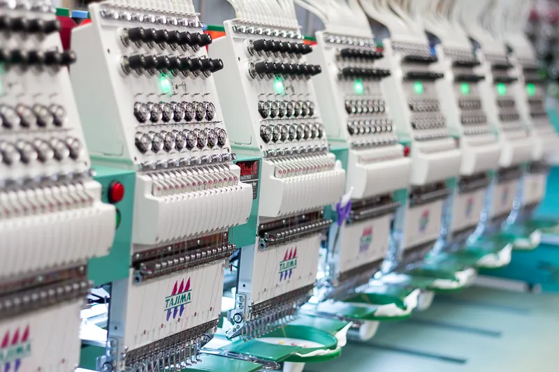 Multi-head embroidery machines stitching logos