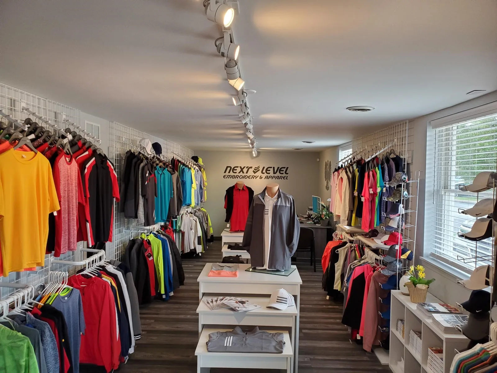 Showroom interior with racks of colorful polos and jackets